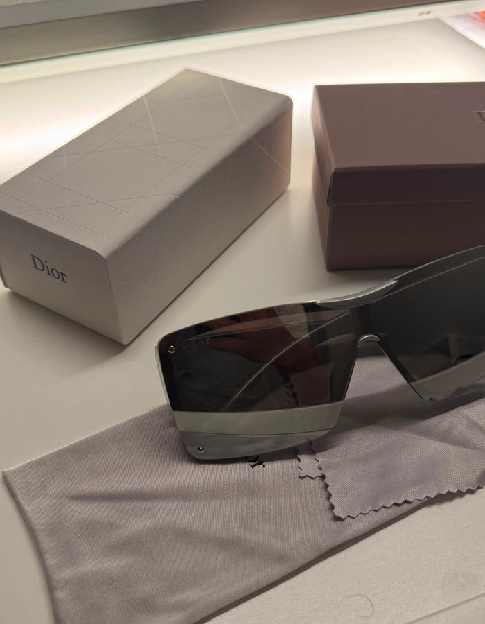 Silver statement sunglasses on cloth with presentation boxes